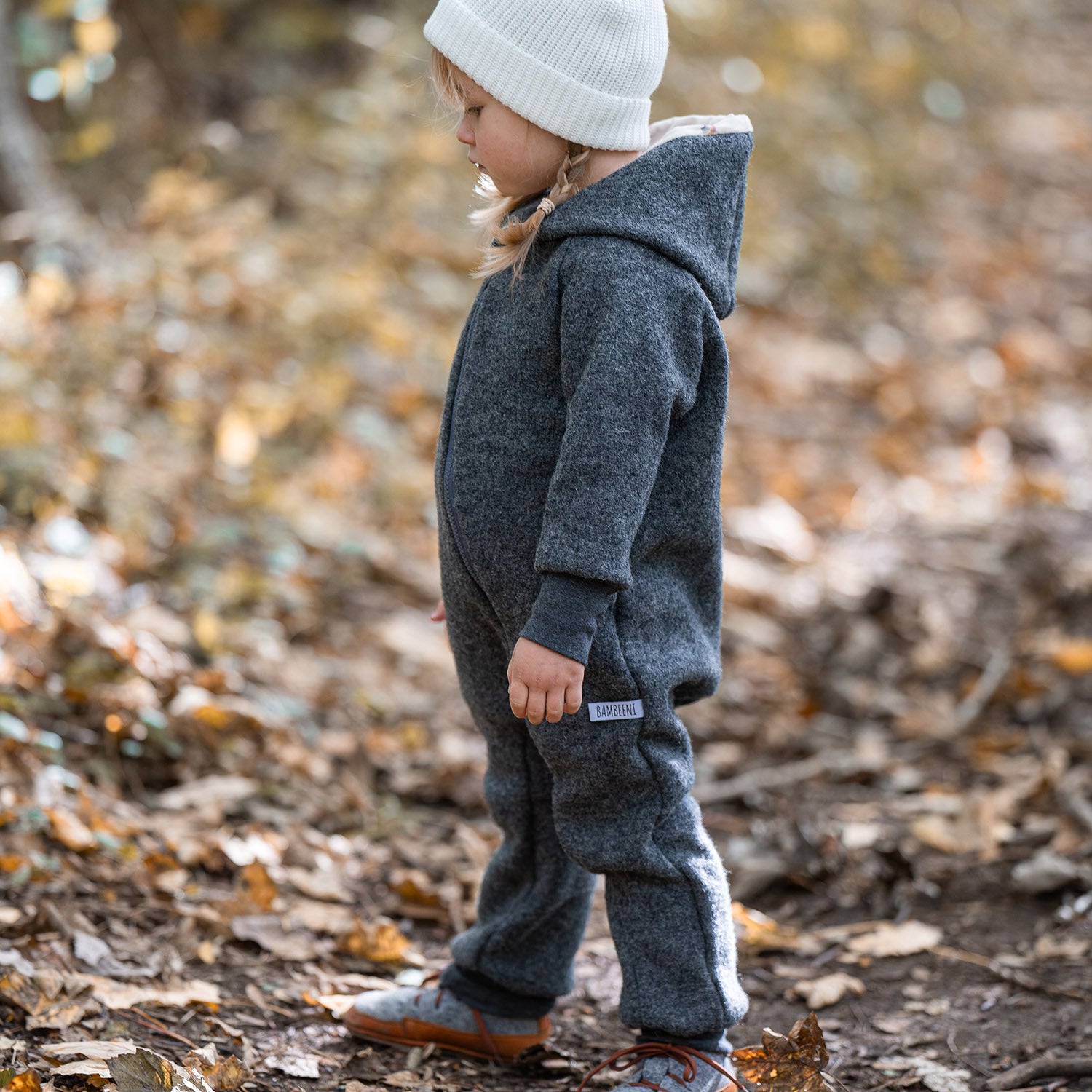 Kind in grauem Walkoverall- Sonne Mond und Regenbogen- Bambeeni Walkoverall für Babys & Kinder aus 100% Schurwolle und Baumwollinnenfutter